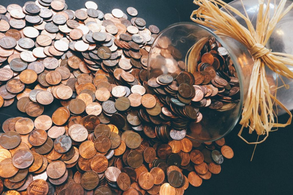pennies collected in a glass jar for fall fundraising ideas