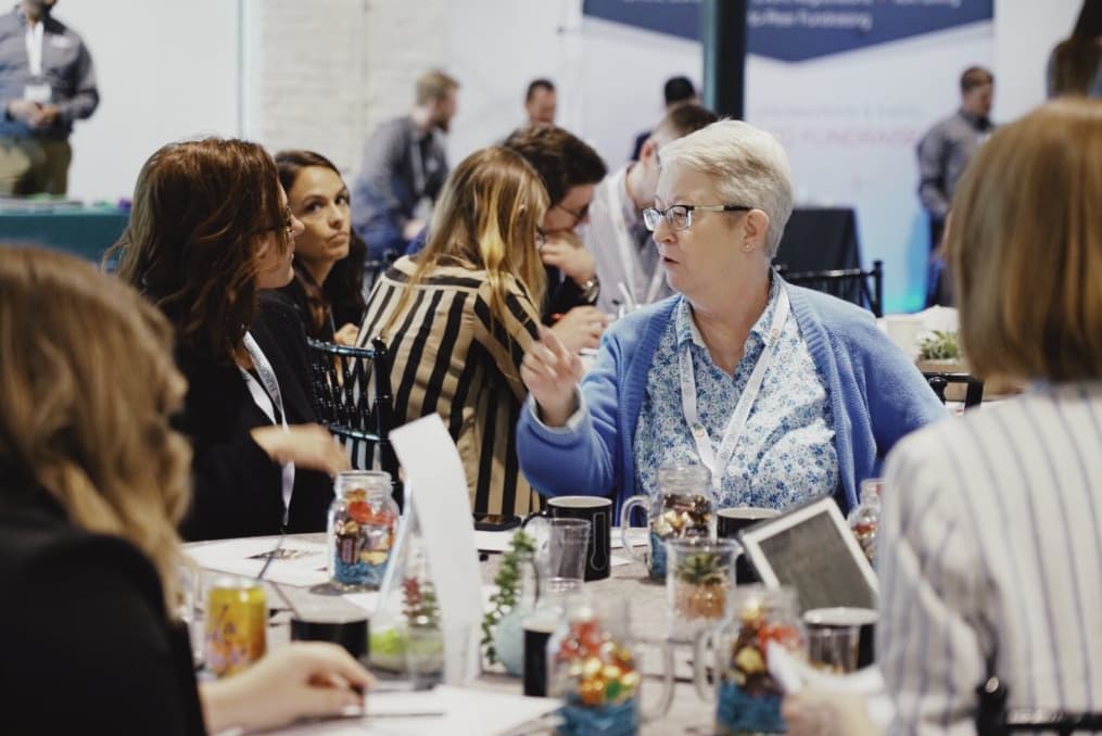 Attendees of the Lakeland Fundraising Lab talking around a table