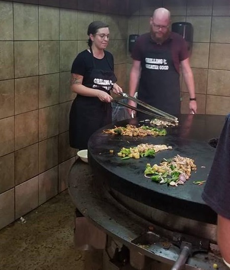 Two Lakeland Volunteers in Medicine staff making stir fry