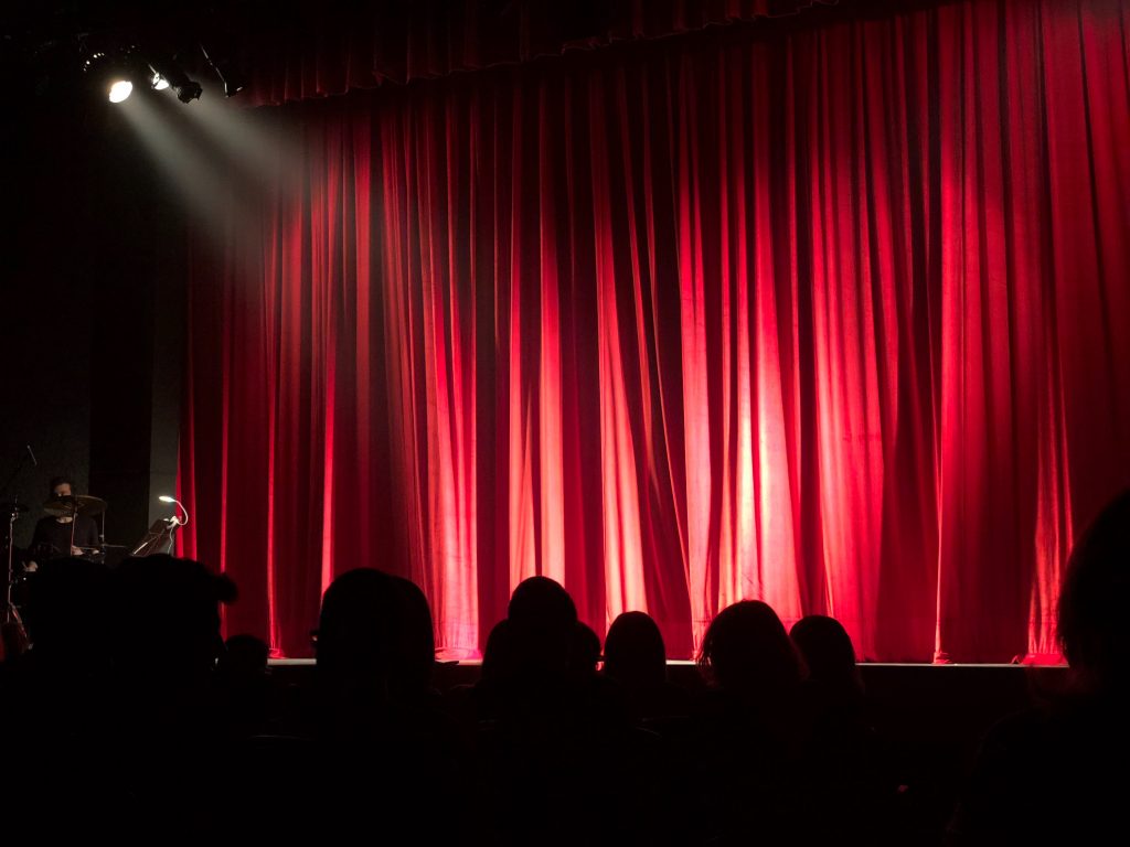 Closed curtain on stage with spotlight