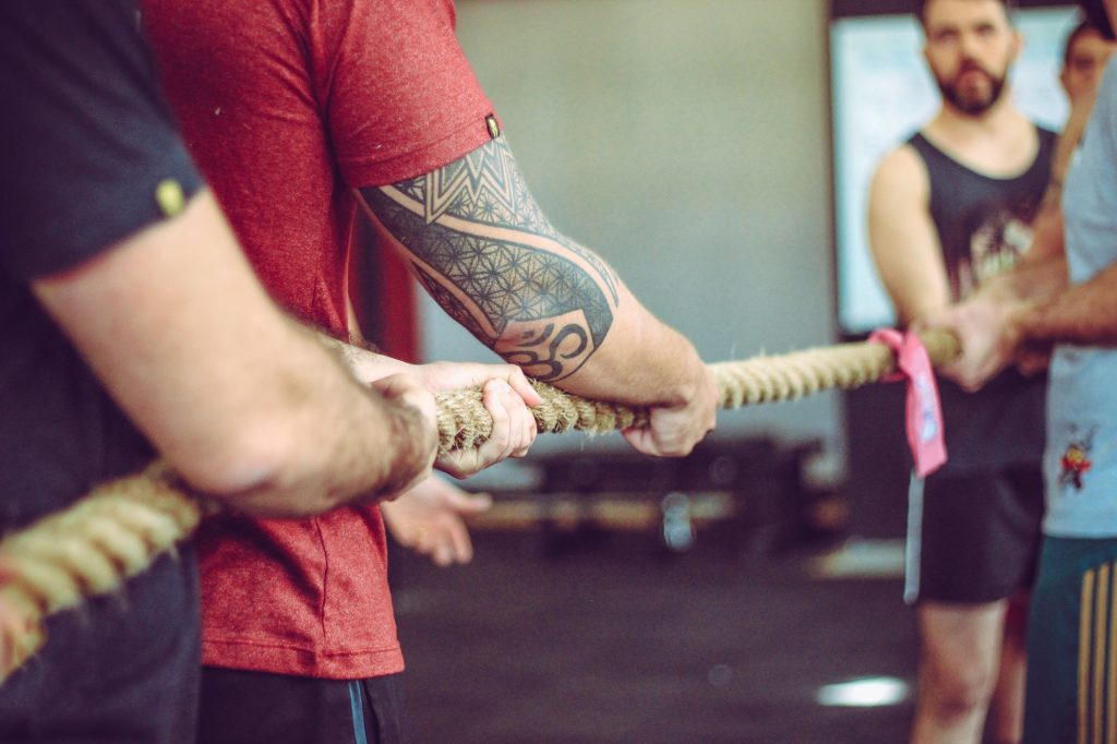 Athletes engaging in a game of tug of war.