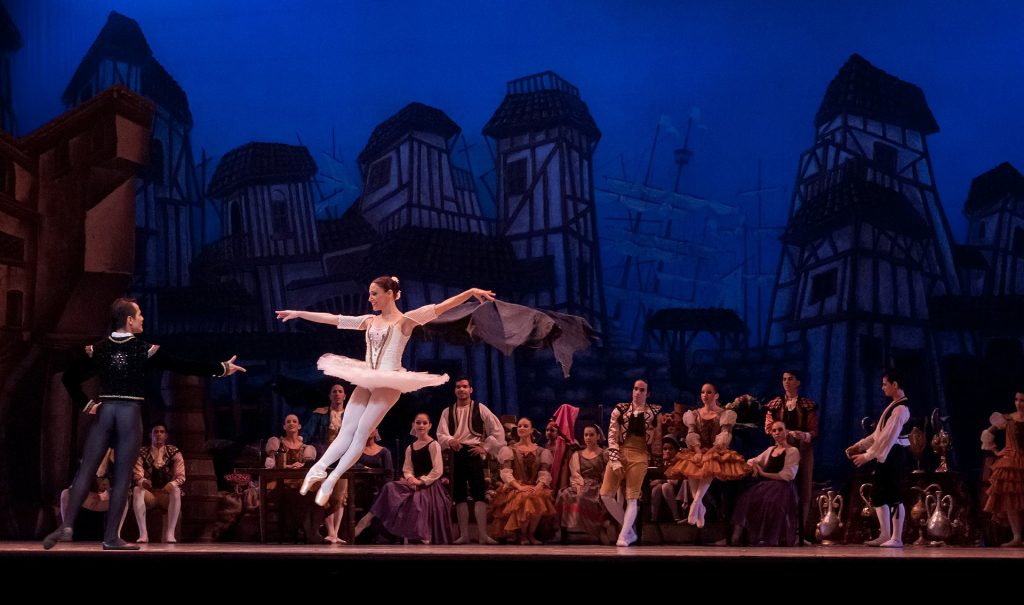 Ballet dancers performing live for an audience. The crew aren't volunteers, but handle much of the production.