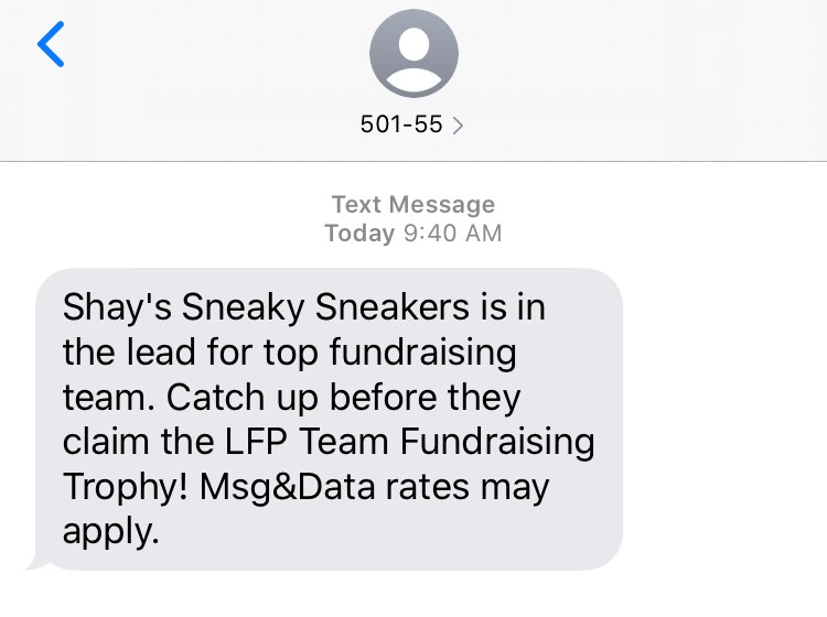 Text message meant to spark competition for top fundraising trophy between peer-to-peer fundraising teams.