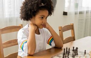 Little girl playing chess