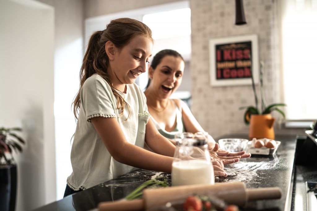 Girl baking with her mother.