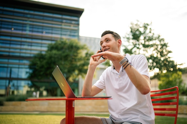 man on a bench outside asking for donations over the phone