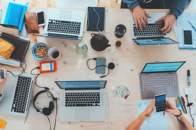 people working at a table of computers for nonprofit social media