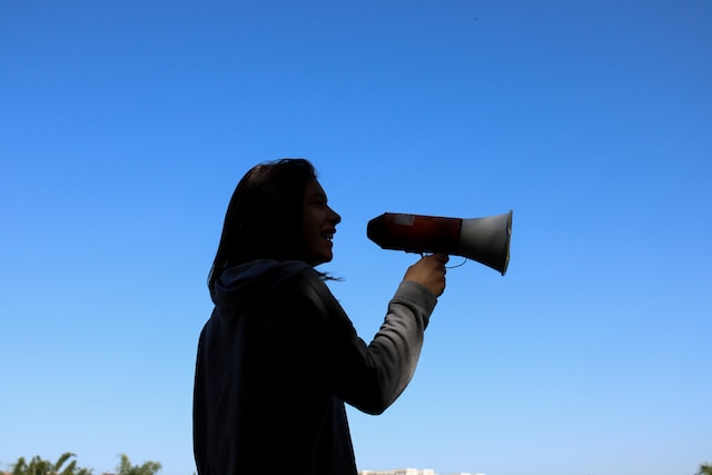 woman spreading the word about spring fundraising event with a megaphone