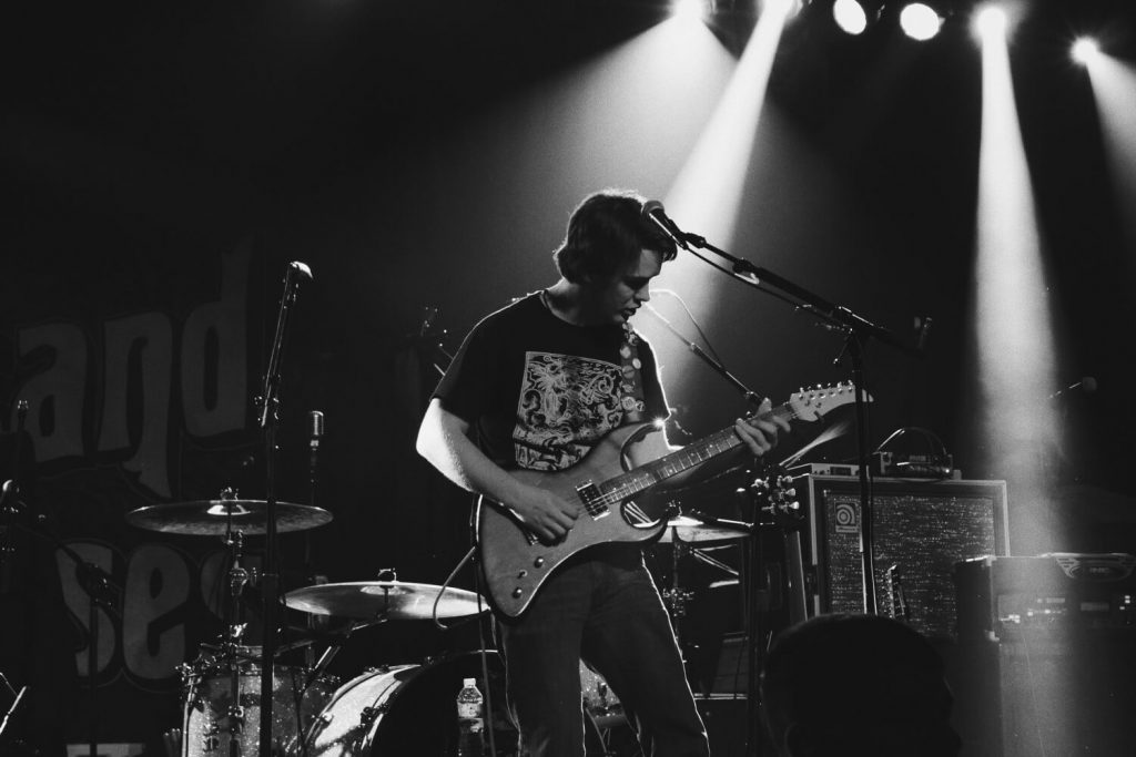 person playing guitar for unique raffle prize ideas