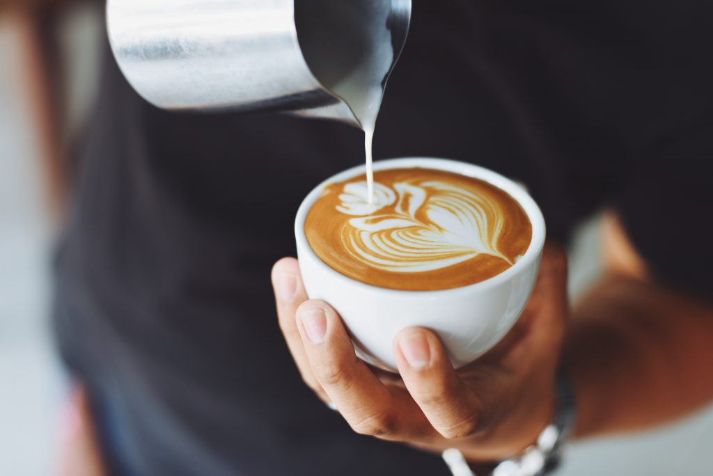 Barista making coffee art.