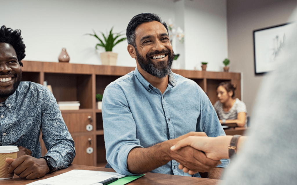 Two men shaking hands to symbolize connections made using CRMs and other nonprofit fundraising tools 