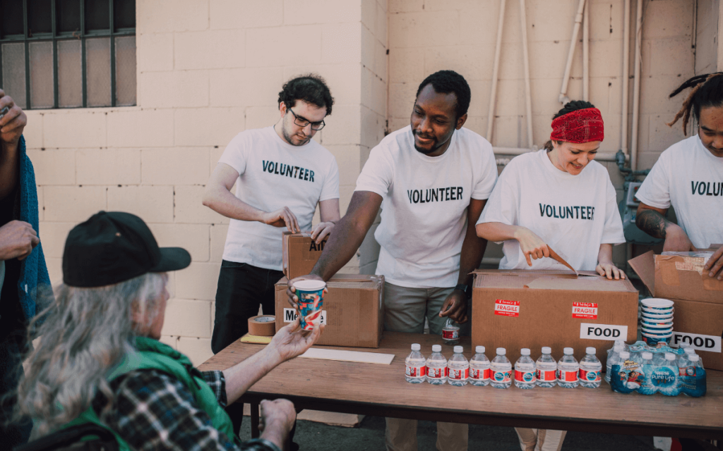 Volunteers handing out food and water to symbolize the other nonprofit fundraising platforms and tools available to fundraisers