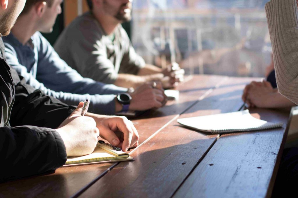 Employees sitting at a table for a meeting