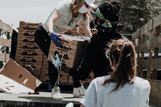 volunteers helping move supplies for a pledge drive