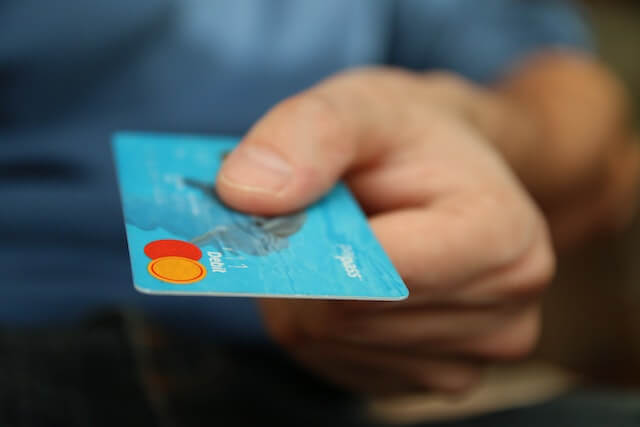 A person holds onto their debit card.