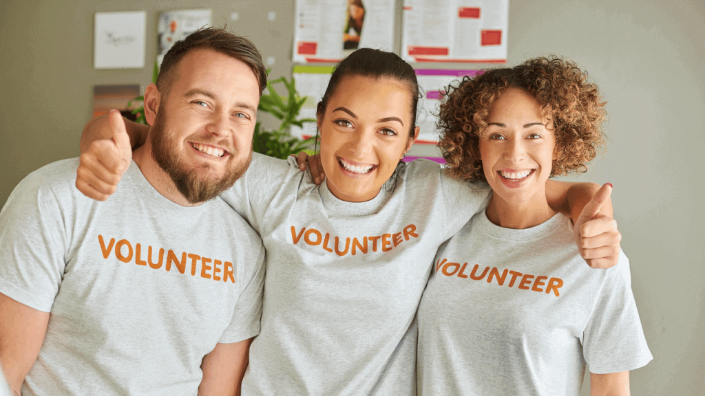 three volunteers smiling