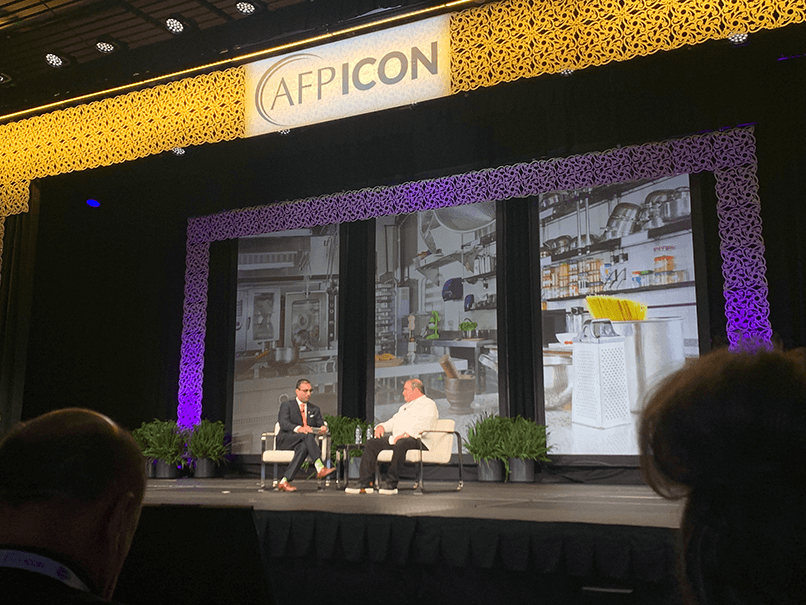 Emeril Lagasse and Cherian Koshy on stage at AFP ICON 2023
