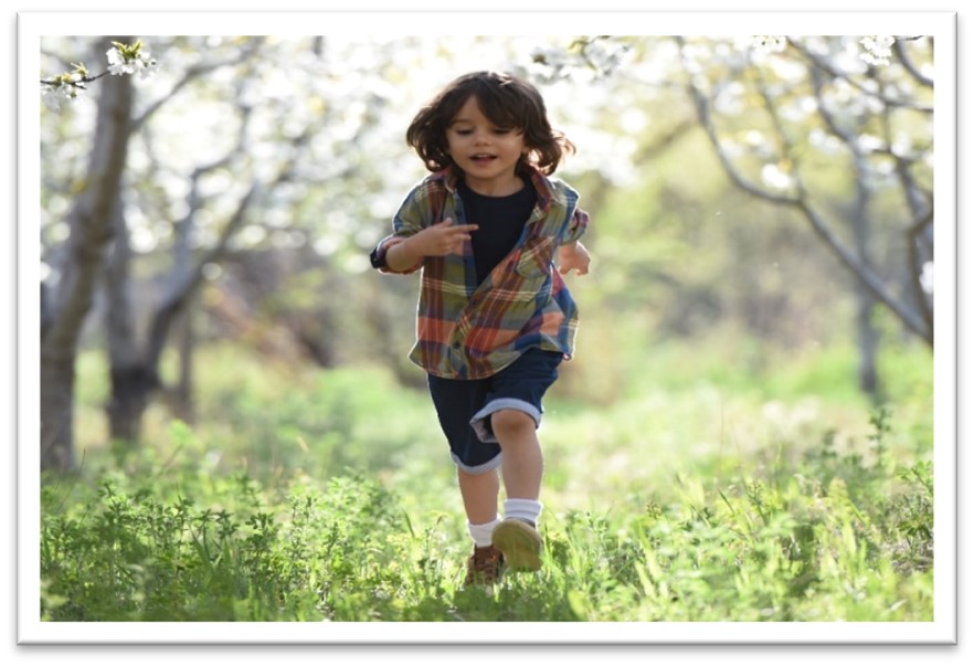 Image of a young child running in a forest for use in an in-kind donation letter