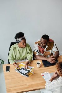 Two people sitting at a business meeting to discuss nonprofit sponsorship. 