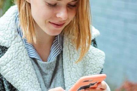 woman using a smartphone for a nonprofit marketing text campaign