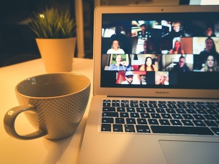 computer on a desk showing an virtual conference call for an online fundraising workshop