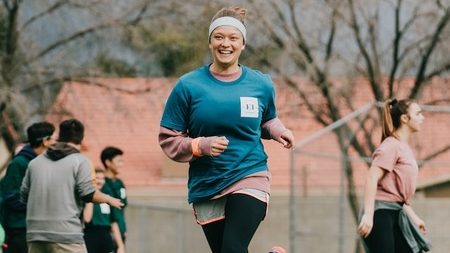 woman running outside to show people in a nonprofit annual report