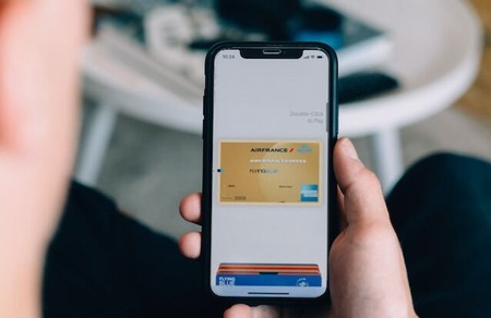 person holding a smartphone showing a digital wallet for GivingTuesday donations