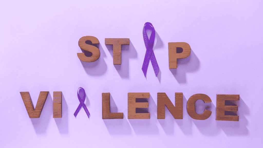 wooden blocks and purple ribbons spelling out "Stop Violence"