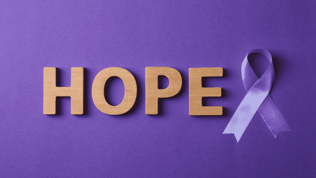 wooden blocks spelling out "Hope" with a purple ribbon