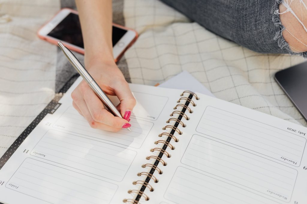 woman writing in planner