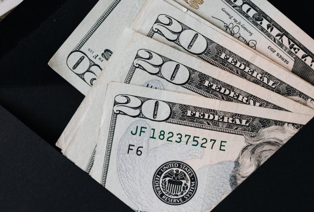 four $20 bills in an envelop for managing nonprofit endowments