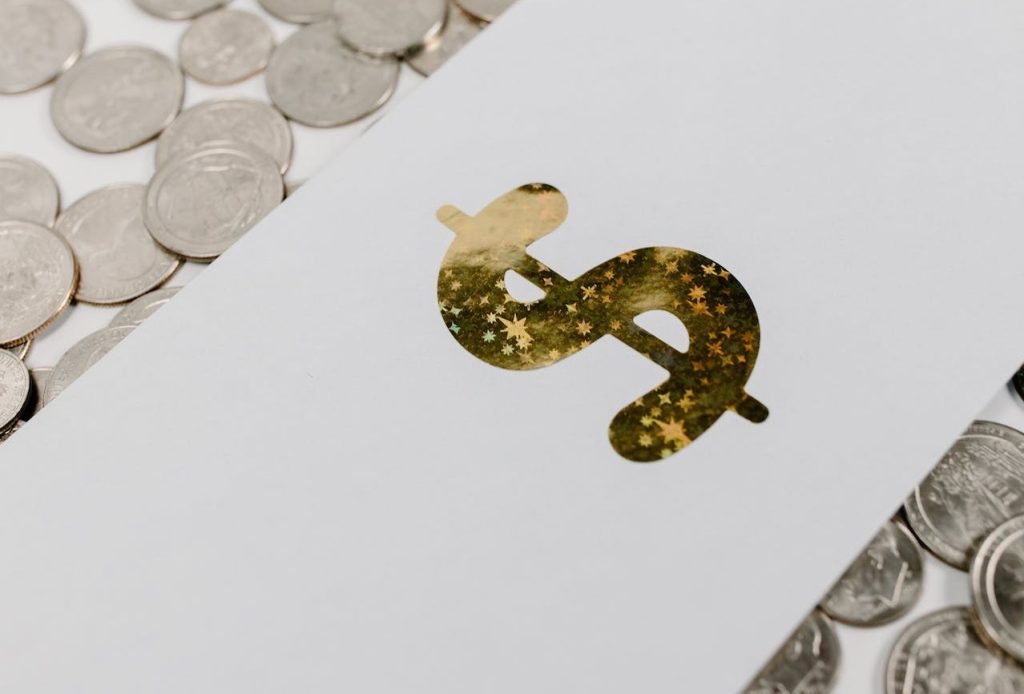 an envelope with a gold $ surrounded by coins to represent growing endowment funds