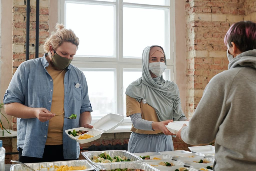 people handing out food to illustrate volunteer-based donor segmentation