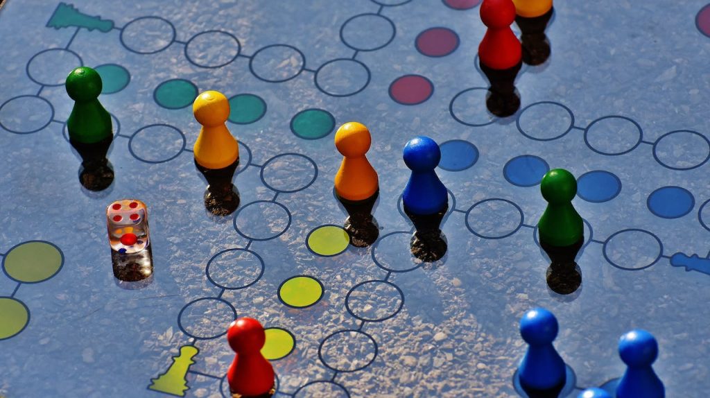 game pieces on a game board representing creating a nonprofit fundraising strategy