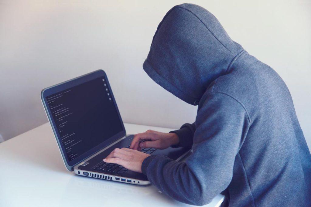someone using a laptop to try to breach the cybersecurity of a nonprofit
