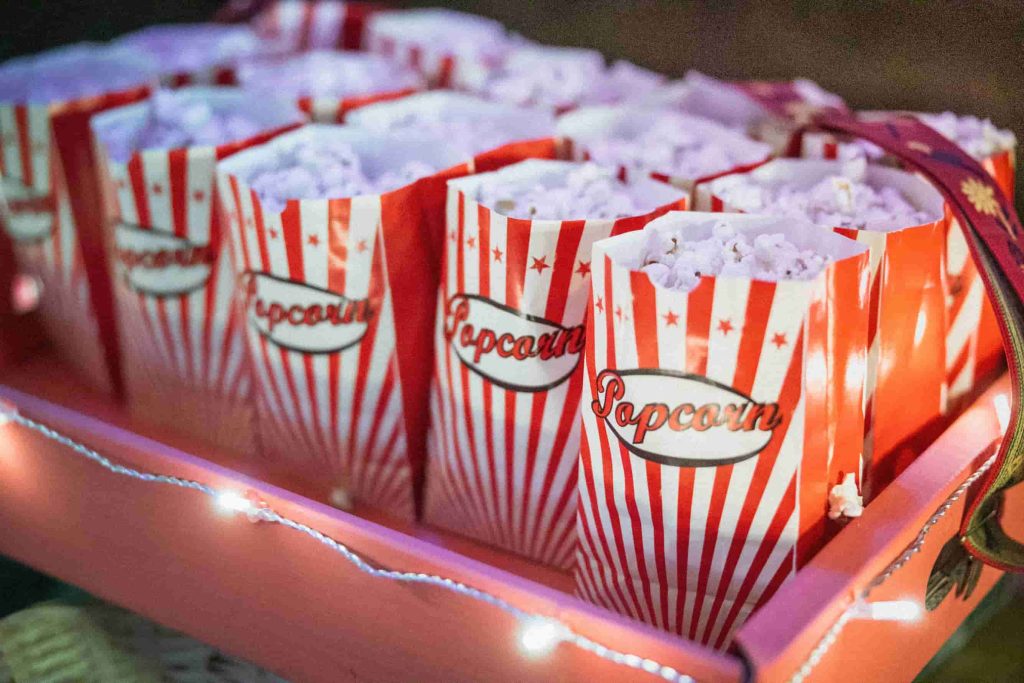 bags of popcorn on a tray for a donor appreciation movie night event