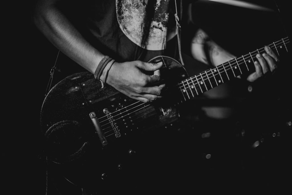 person playing guitar at a benefit concert