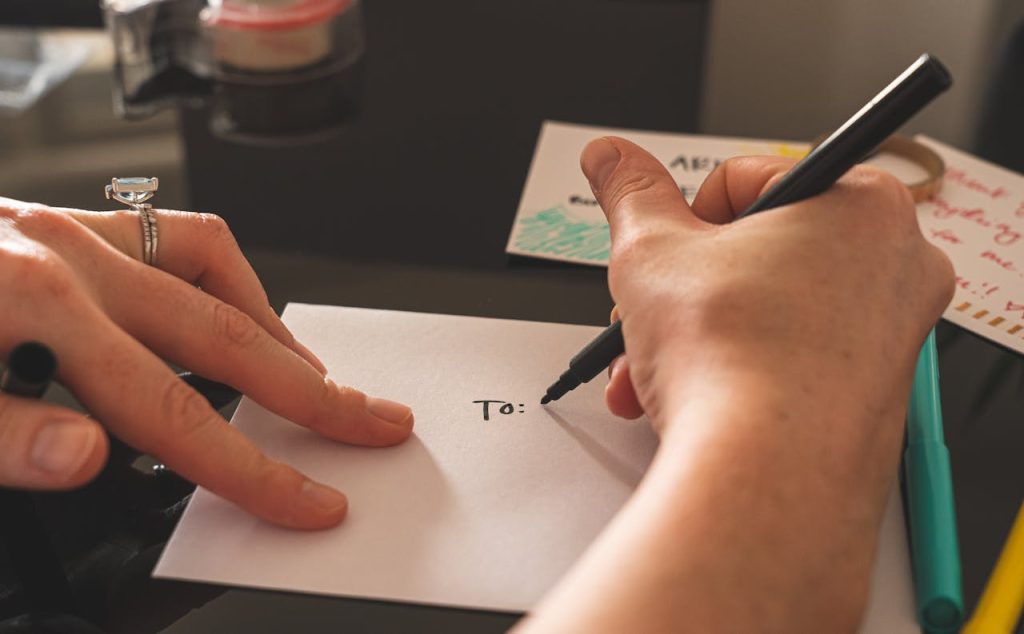 person writing a letter to appeal to potential legacy giving donors